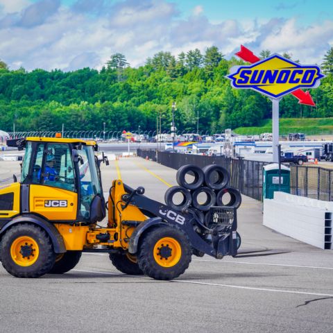 New Hampshire Motor Speedway Senior Operations Manager Nick Duggan uses a loader to move tire packs to pit road as part of the transition from Motorcycle Week at NHMS to the June 21-23 NASCAR weekend.