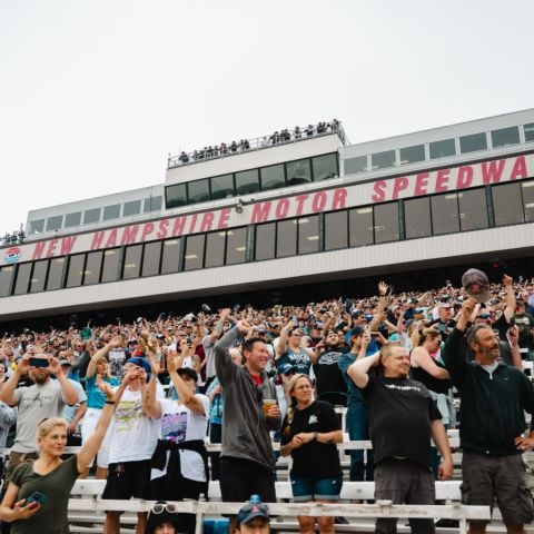 Fans cheer as the NASCAR Cup Series field comes to the green flag at New Hampshire Motor Speedway on June 23, 2024.